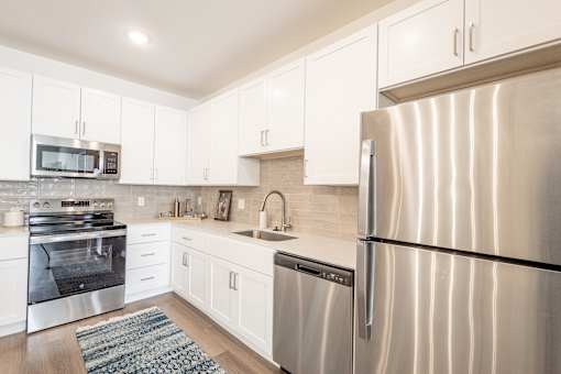A modern kitchen with a stainless steel refrigerator.