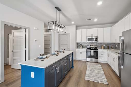 Modern kitchen with island and white cabinets at Viridian Apartments, Bowling Green, 42104