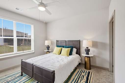 Bright bedroom with large window and ceiling fan at Viridian Apartments, Kentucky