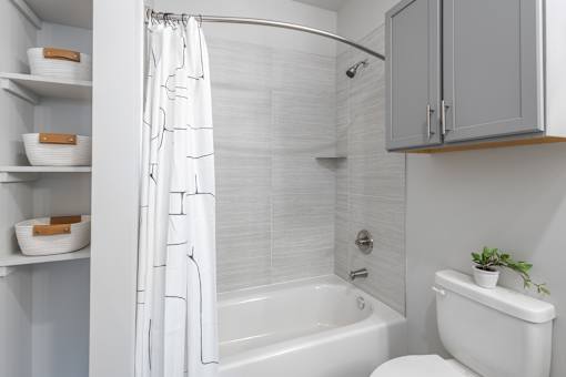 A white bathroom with a toilet, sink, and bathtub.