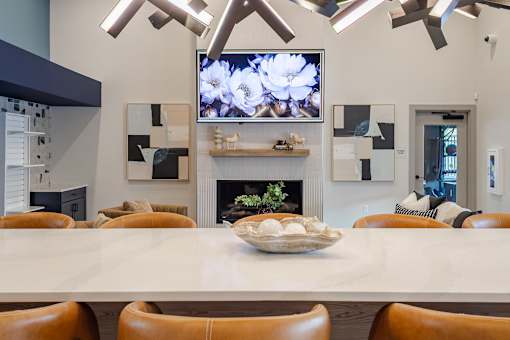 A modern dining room with a large table and chairs.