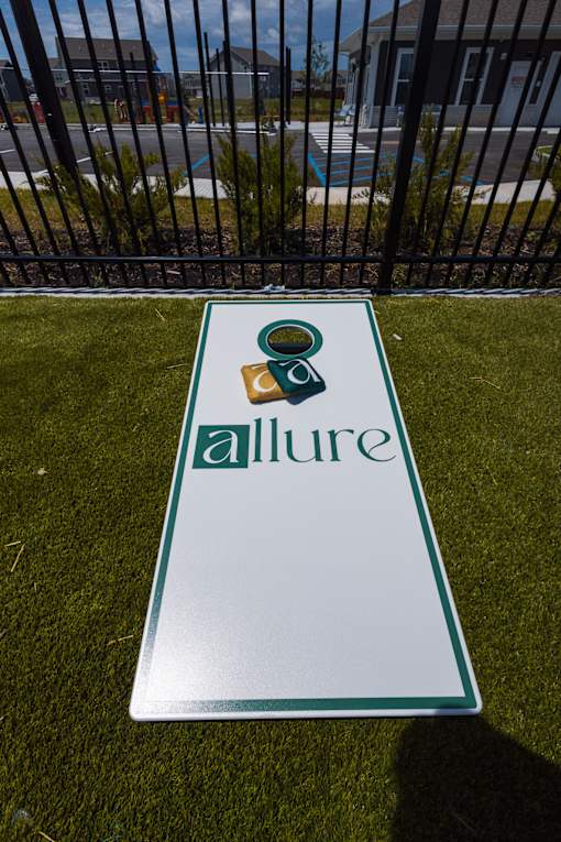 Cornhole board on grass near pool area at Allure Apartments, Indiana, 46184