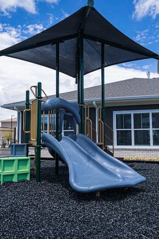 Playground with slides and shade canopy at Allure Apartments, Whiteland