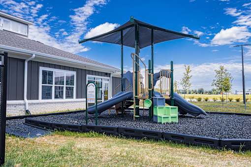 Playground with slides and shade cover at Allure Apartments, Indiana