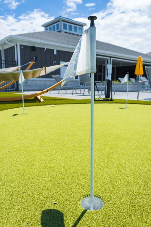 Putting green with flag and outdoor lounge area at Allure Apartments, Whiteland, Indiana