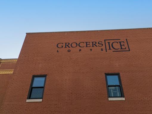 The Grocers Lofts building has a red brick exterior.