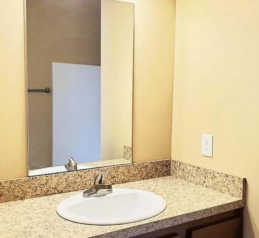 A bathroom sink with a mirror above it.