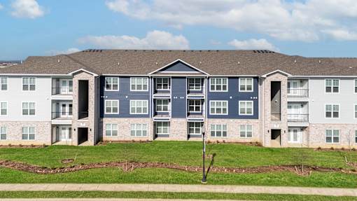 A large apartment complex with multiple buildings and balconies.