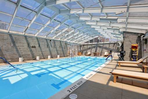 A swimming pool with a glass ceiling and a 3 feet deep sign.
