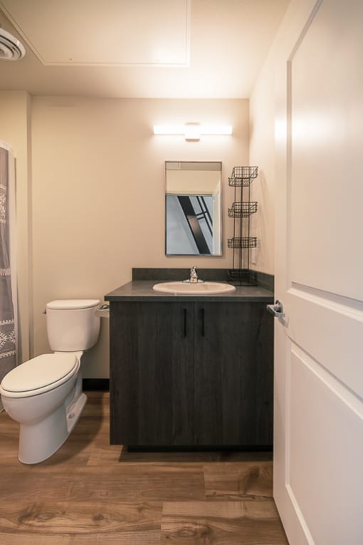 a small bathroom with a toilet sink and mirror