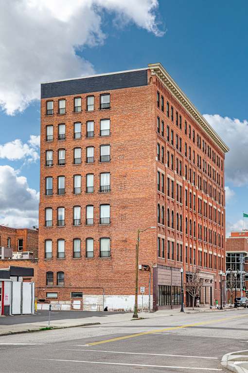 A large red brick building with a black roof and a white door at 206 Flats Apartments, Spokane, Washington
