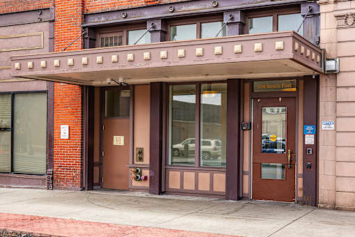 The front of a building with a brown door and a sign at 206 Flats Apartments, Spokane 99201