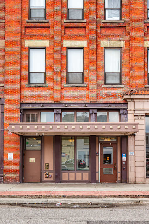A red brick building with a brown door and windows at 206 Flats Apartments, Spokane, WA