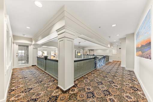 A large, empty room with a patterned carpet and a painting on the wall at 206 Flats Apartments, Spokane 99201