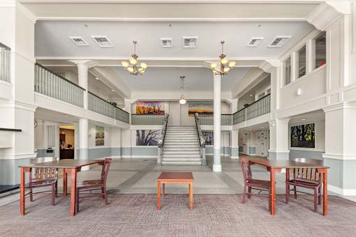 A large room with tables and chairs and a staircase at 206 Flats Apartments, Spokane, WA, 99201