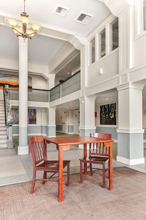 A dining table with two chairs in a room with a staircase at 206 Flats Apartments, Spokane, WA