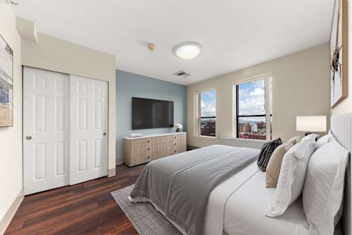 A bedroom with a large bed and a television at 206 Flats Apartments, Washington, 99201