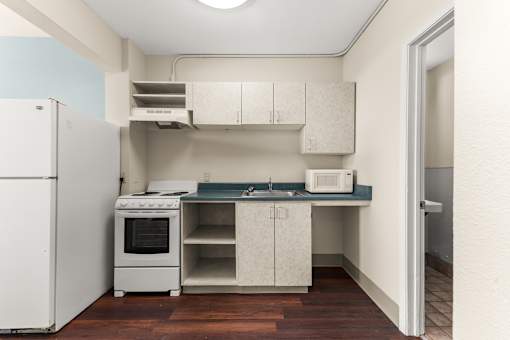 A kitchen with white appliances and cabinets at 206 Flats Apartments, Spokane 99201