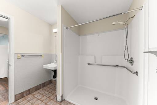 A white bathroom with a walk in shower at 206 Flats Apartments, Washington, 99201