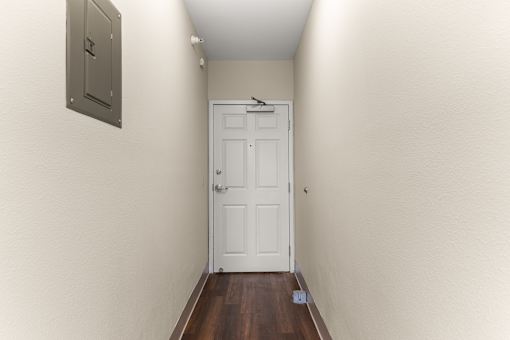 A white door is at the end of a hallway at 206 Flats Apartments, Washington, 99201