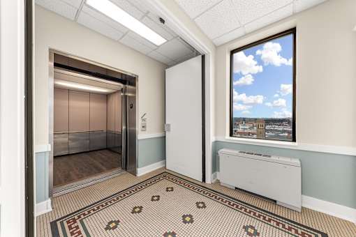 A room with a tiled floor and a window showing a cloudy sky at 206 Flats Apartments, Spokane 99201