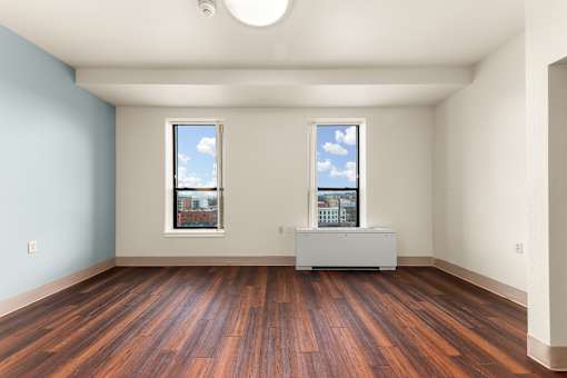 A room with wooden floors and two windows at 206 Flats Apartments, Spokane, WA