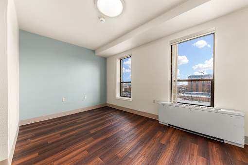 A room with a window and a radiator on the floor at 206 Flats Apartments, Spokane, WA, 99201