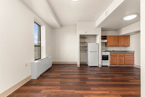 A kitchen with wooden floors and white appliances at 206 Flats Apartments, Washington