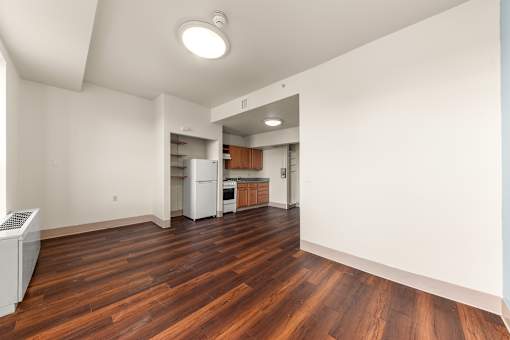 A kitchen with white appliances and wooden floors at 206 Flats Apartments, Spokane 99201