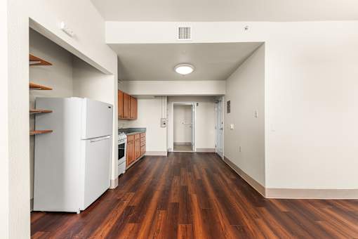 A kitchen with a white refrigerator and wooden floors at 206 Flats Apartments, Spokane, WA, 99201
