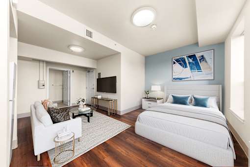 A bedroom with a white bed and a white chair at 206 Flats Apartments, Washington, 99201