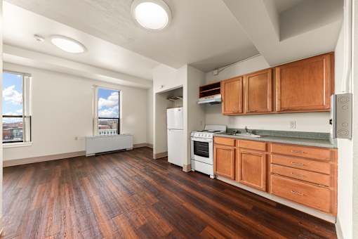 A kitchen with wooden floors and white appliances at 206 Flats Apartments, Spokane