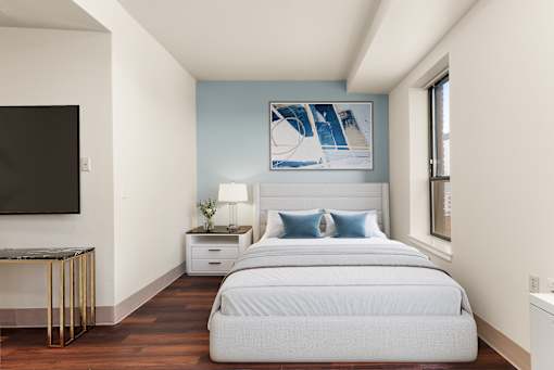 A bedroom with a large bed and a painting at 206 Flats Apartments, Washington, 99201