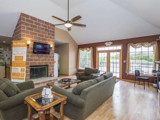 a living room with couches a coffee table and a fireplace