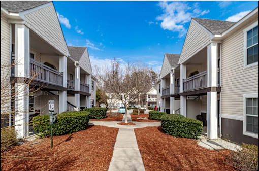 Apartment complex with a walkway in the middle.