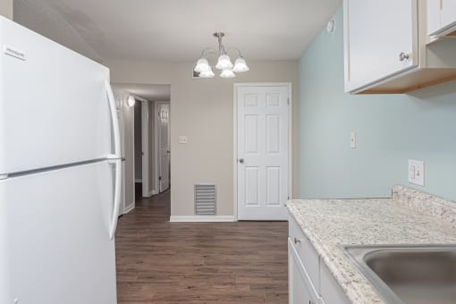 a kitchen with white cabinets and a black dishwasher