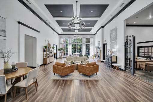 the living room of a new home with furniture and a chandelier