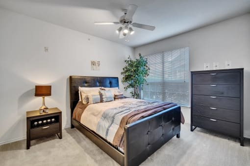 a bedroom with a large bed and a ceiling fan