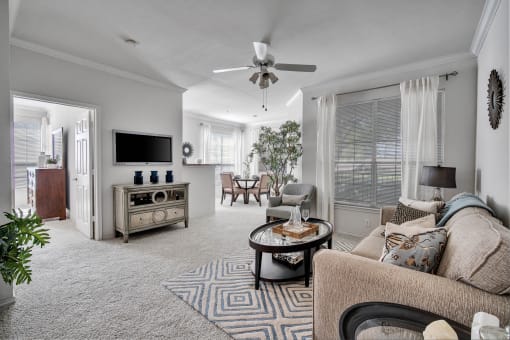 a living room with a ceiling fan and a couch
