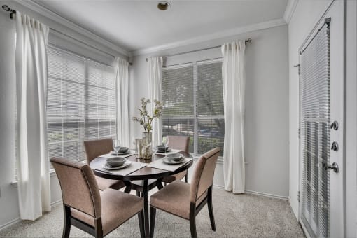 a dining room with a table and chairs