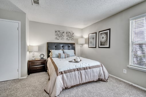 the master bedroom has a king sized bed and a window