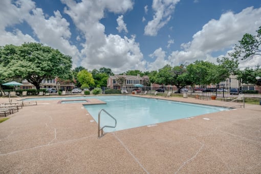 the preserve at ballantyne commons community swimming pool with trees and buildings