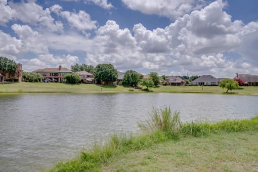 a body of water with houses in the background