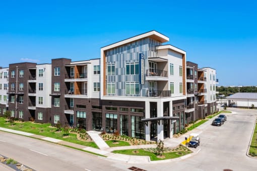a large apartment building with a street in front of it