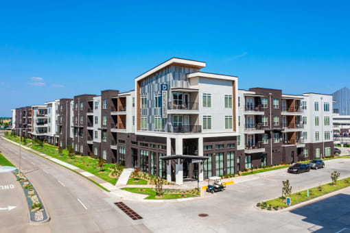 a large apartment building with a street in front of it