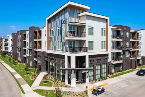 a new apartment building with a parking lot in front of it