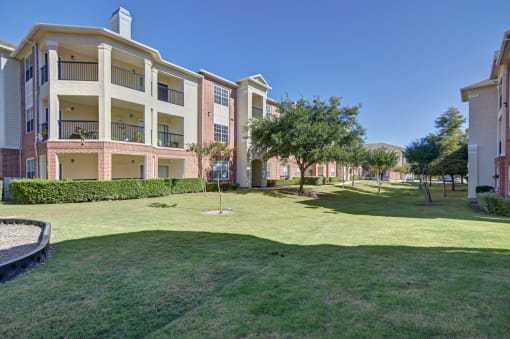 Exterior of buildings with lots of green space  at Clearwater Creek, Richardson