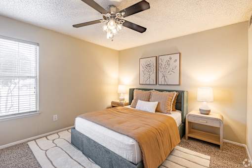 Bedroom with upholstered headboard and nightstand at Highland Park Apartments, Fort Worth, 76132