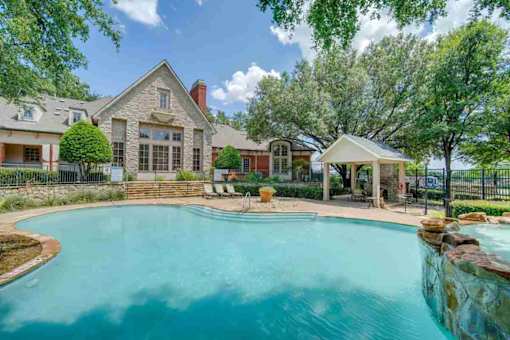 a swimming pool with a house in the background