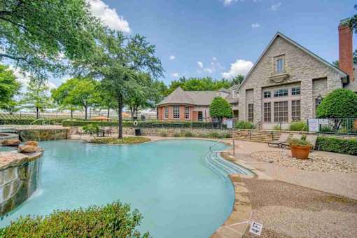 a swimming pool with a house in the background